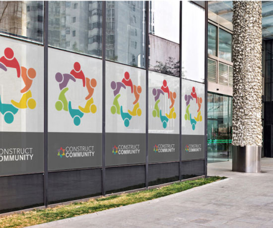 A vibrant building adorned with various colorful signs on its exterior, showcasing a lively urban atmosphere.