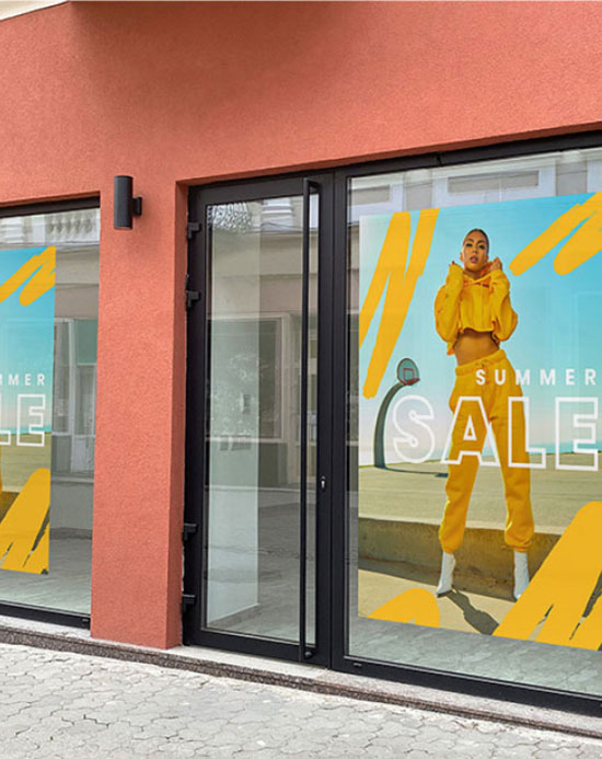 A store front featuring a vibrant yellow and orange banner promoting a summer sale.