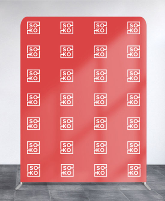  A vibrant red wall featuring a combination of white and red logos, creating a striking visual contrast.