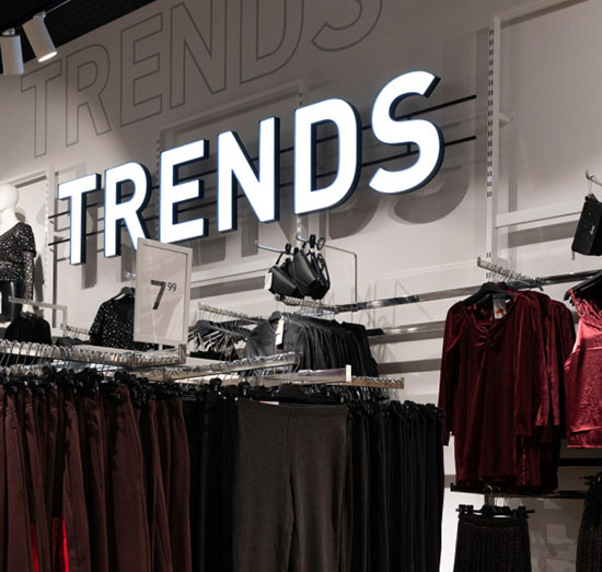 A clothing store featuring a prominent sign displaying the word 'Trends,' showcasing modern fashion styles.