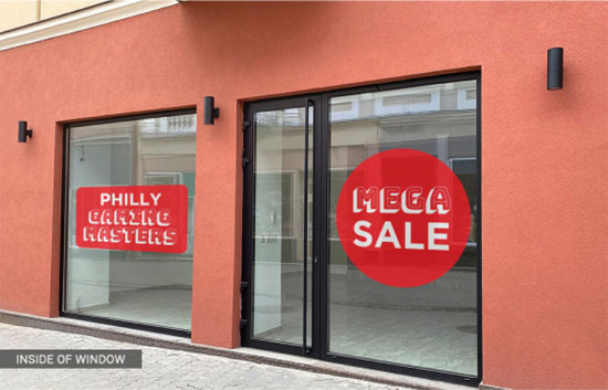 A storefront displaying a sign that reads 'Philly Sale,' inviting customers to explore special offers inside.