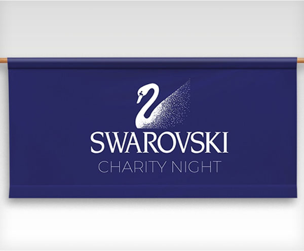 Swarovski charity night banner featuring elegant design and logo, promoting a philanthropic event for a noble cause.