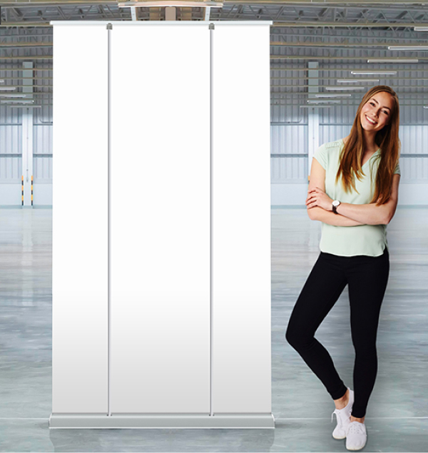 A woman stands beside a large roll-up banner, showcasing a professional and engaging display.