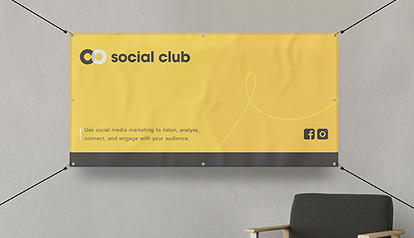 A yellow banner displayed on the wall beside a chair, creating a vibrant and inviting atmosphere in the room.