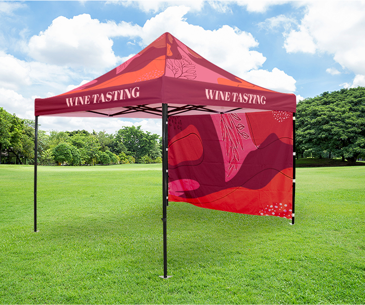 A red canopy tent featuring a wine tasting logo, set up for an outdoor event or festival.