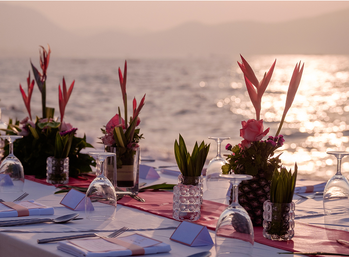 A vibrant red tablecloth drapes elegantly over a wooden table, adding a pop of color to the setting.