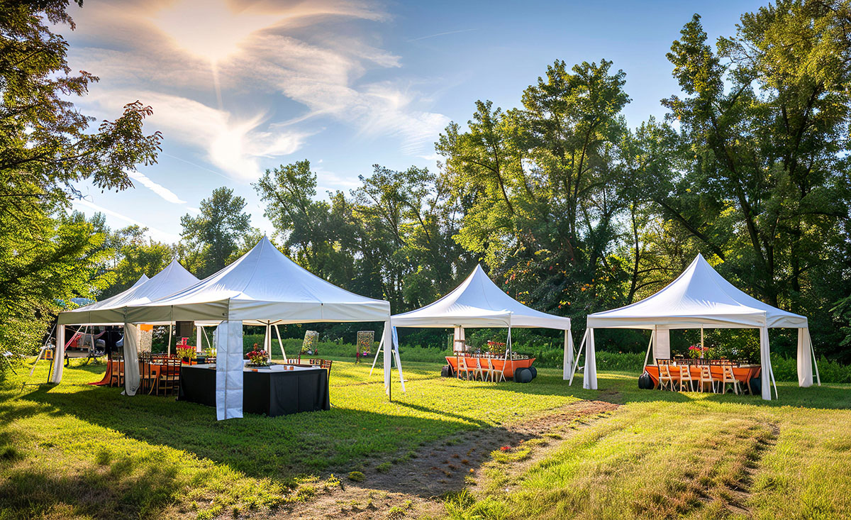 Outdoor wedding tent set up with elegantly arranged tables and chairs for a beautiful celebration.